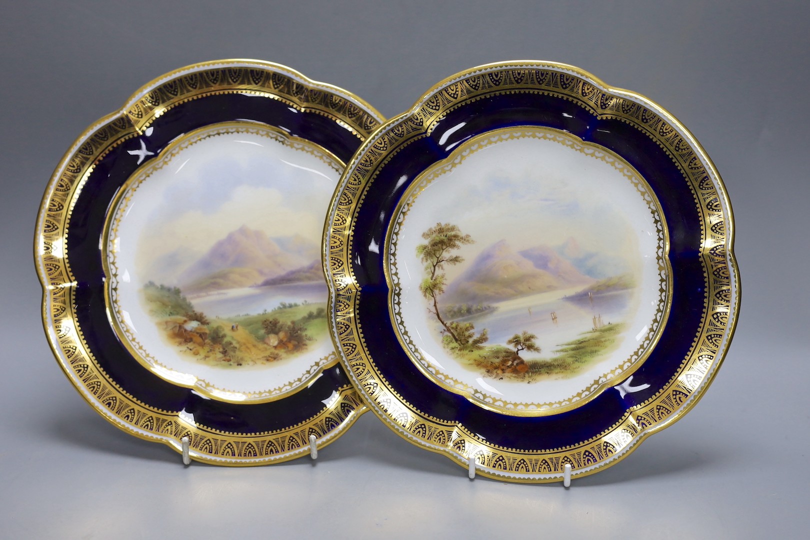 A pair of Coalport plates painted with Scottish loch scenes, Ben Lomond and Loch Ard c. 1850 cf. Michael Messanger, Coaport Porcelain, page 289, plate 230 for an example of this shaped plate, 24 cms.